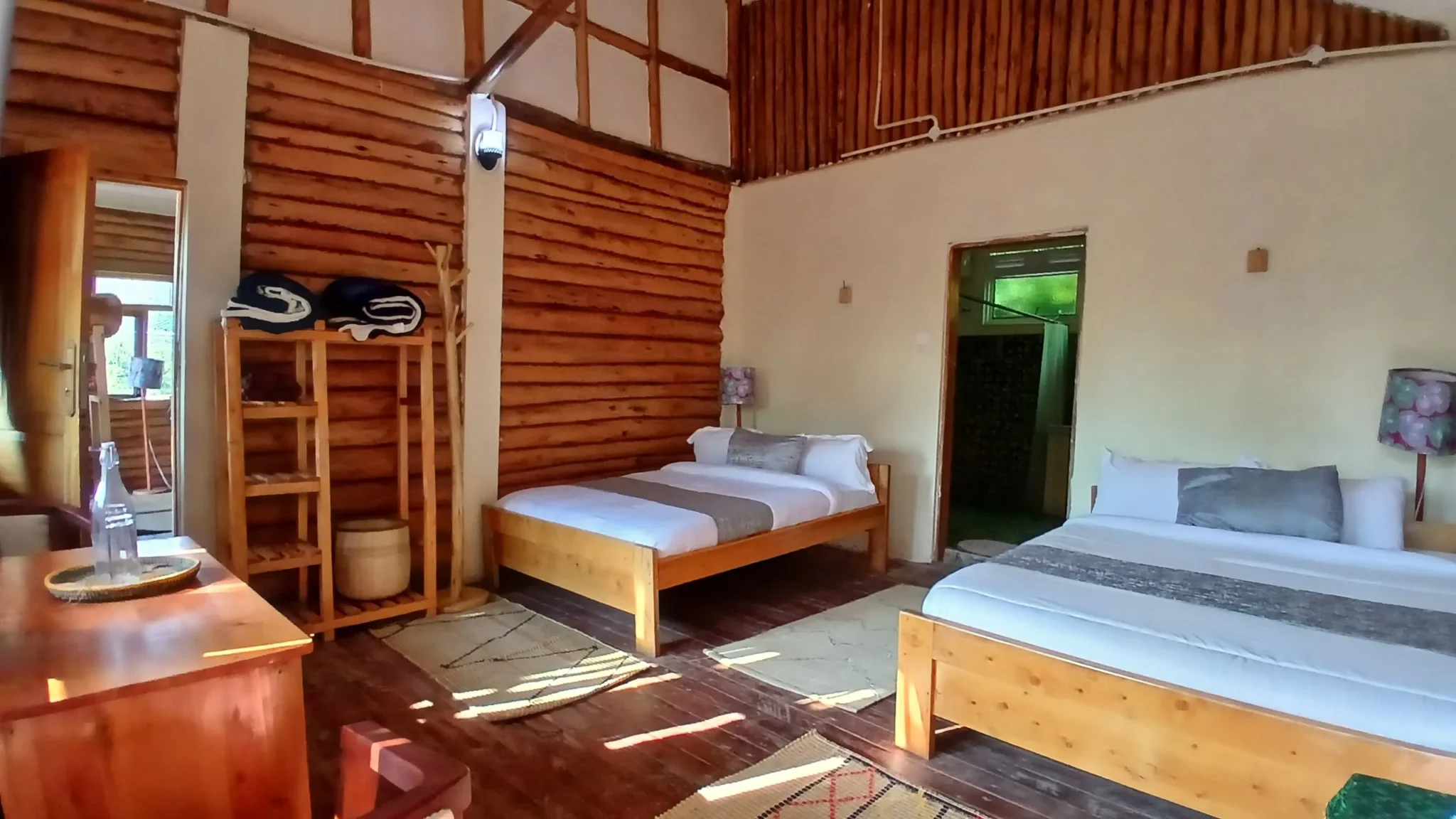 Twin room section of the Family Room at Orugano Bwindi Lodge, showing the door to the parents room